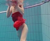 Red Dressed teen swimming with her eyes opened from jackline dress open